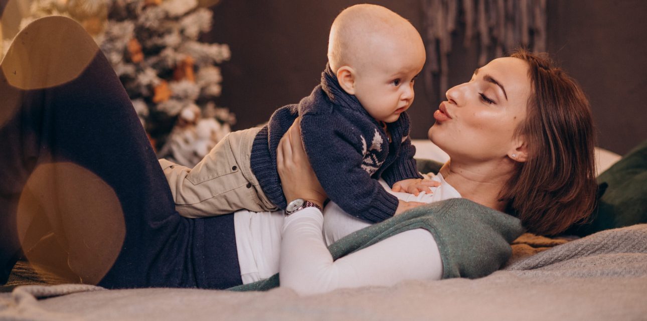 Mother with her baby boy celebrating christmas